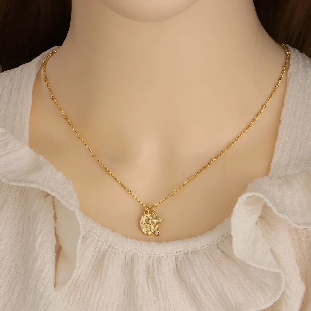 Gold Virgin Mary cross necklace with geometric pendant on 18K copper chain