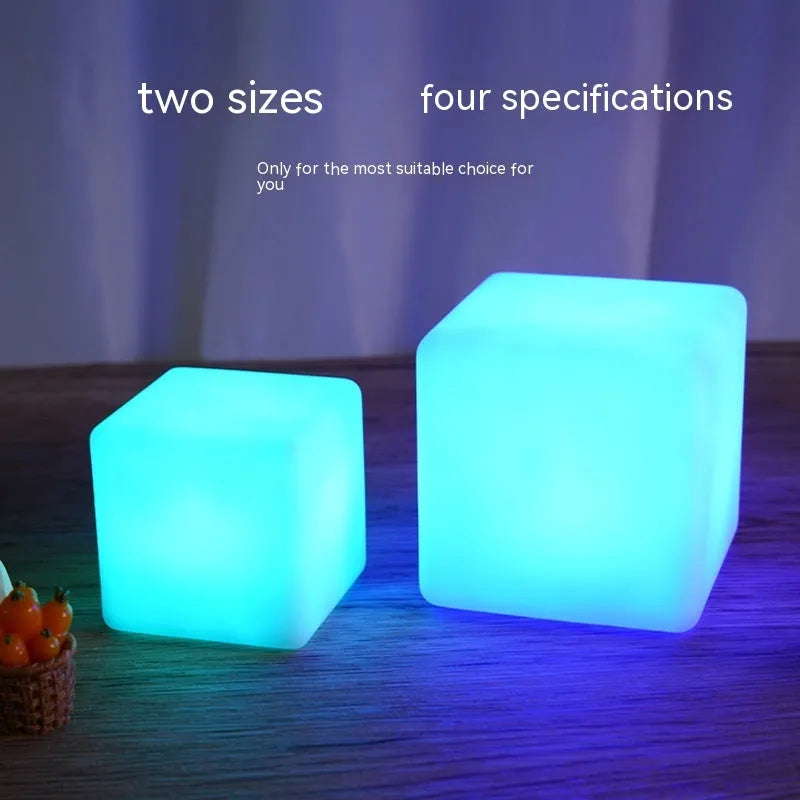 Small square night light showing seven colour changing modes, with remote control.