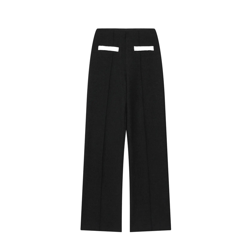 Women's two-piece street fashion suit with beaded leather detail on top and stretch high-waisted trousers