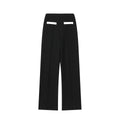 Women's two-piece street fashion suit with beaded leather detail on top and stretch high-waisted trousers