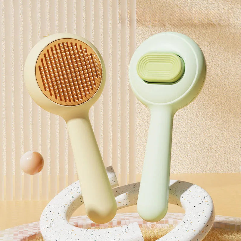 Green and yellow cat grooming brush with stainless steel comb and non-slip silicone handle.