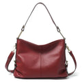 Square vertical genuine leather crossbody bag with multiple internal compartments including phone pocket.