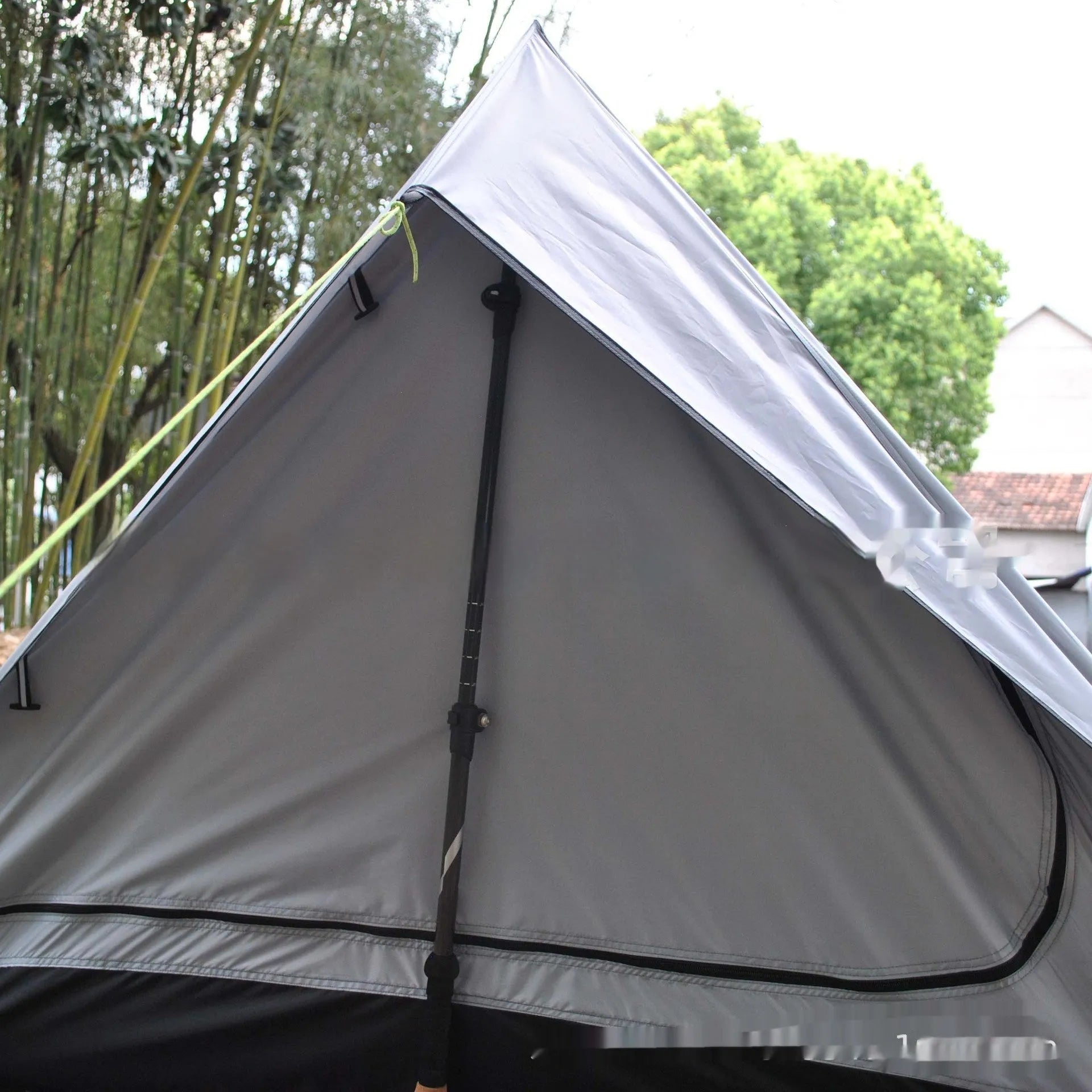Brown A-line pole-free portable tent with hiking cane support showing interior space for 2-3 people
