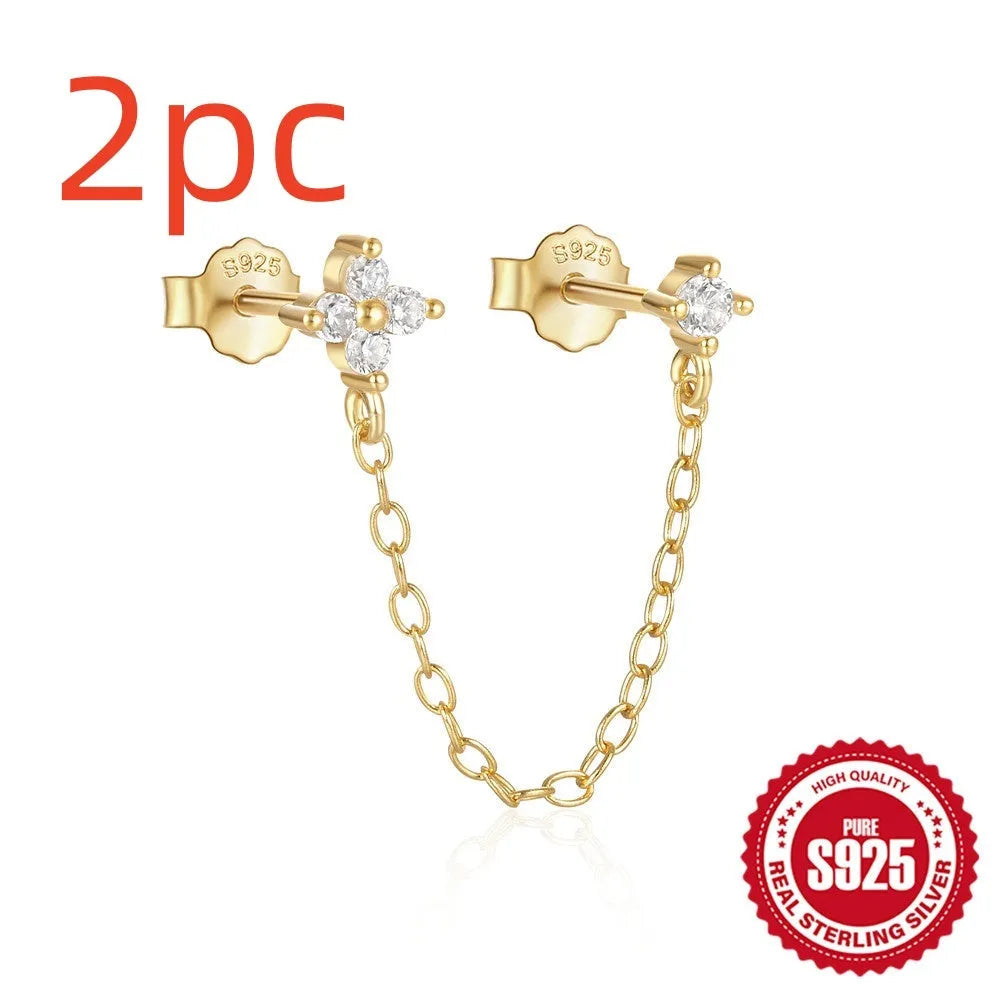 Close-up of a women's S925 sterling silver stud earring with a diamond flower, chain, and tassel design in a gold colour.