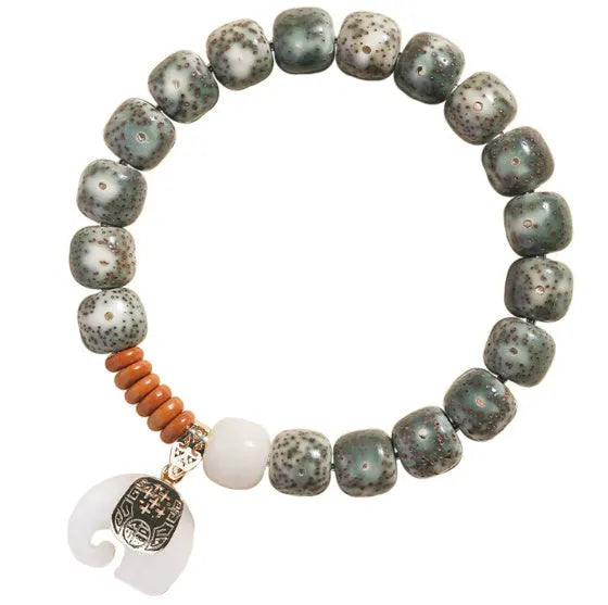 Jade green star moon bodhi bracelet with 10mm geometric beads on white background