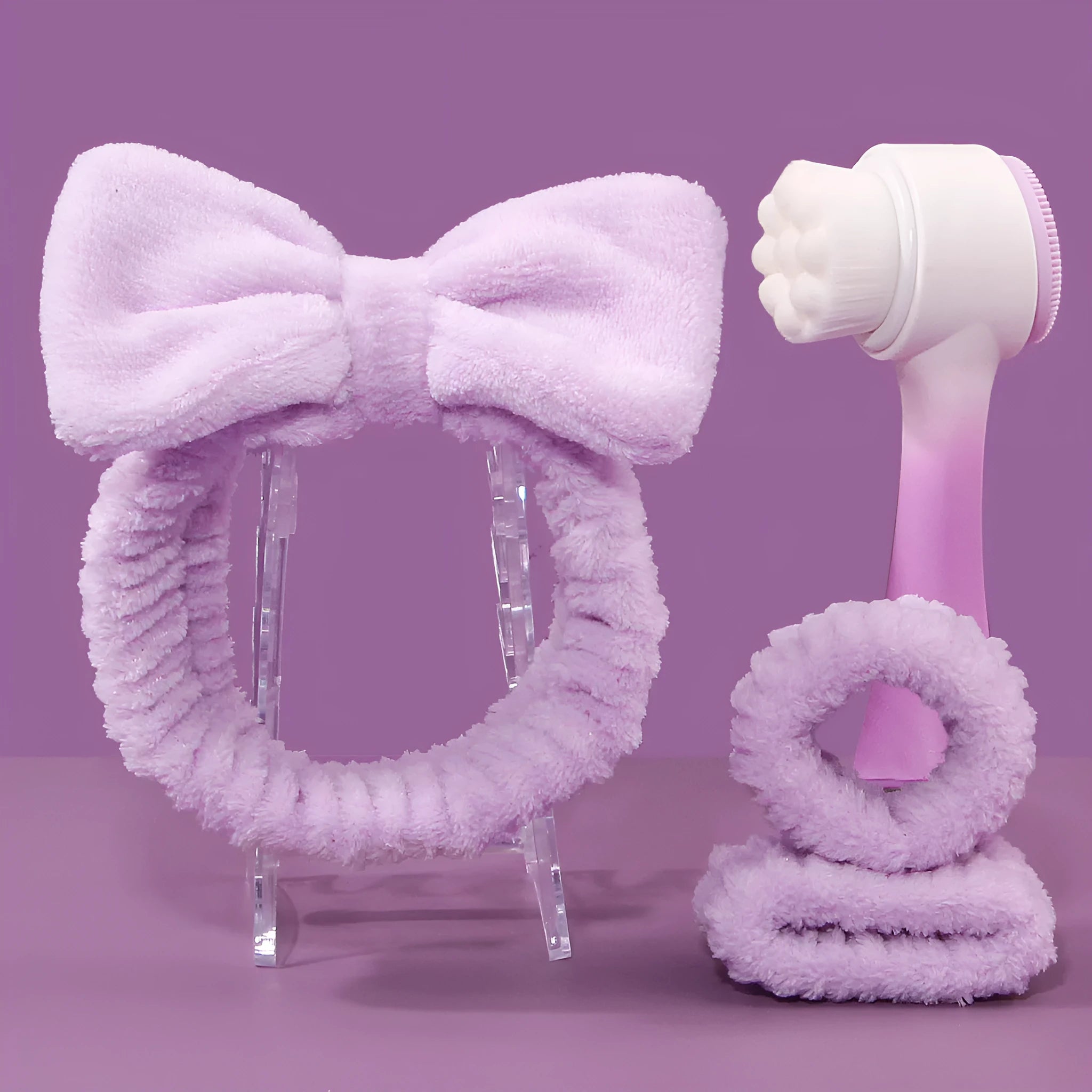 Facial brush and coral fleece hair band set in purple colour with plastic handle and nylon bristles