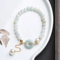 Jade and pearl bracelet with emerald peace buckle clasp and round pendant