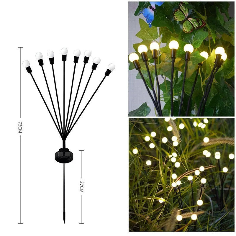 Solar-powered LED firefly lawn light with ground stake inserted in grass