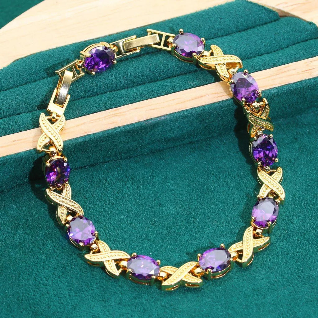 18k gold plated jewellery set showing necklace, earrings, ring and bracelet with coloured cubic zirconia stones.