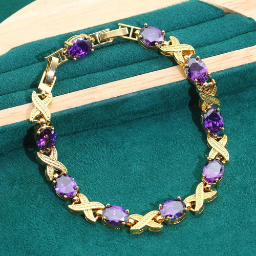 18k gold plated jewellery set showing necklace, earrings, ring and bracelet with coloured cubic zirconia stones.