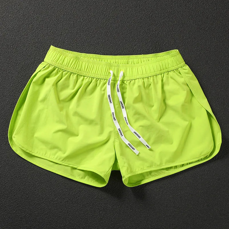 Men's loose-fit polyester surfing trousers in black, fluorescent green, and orange red colours