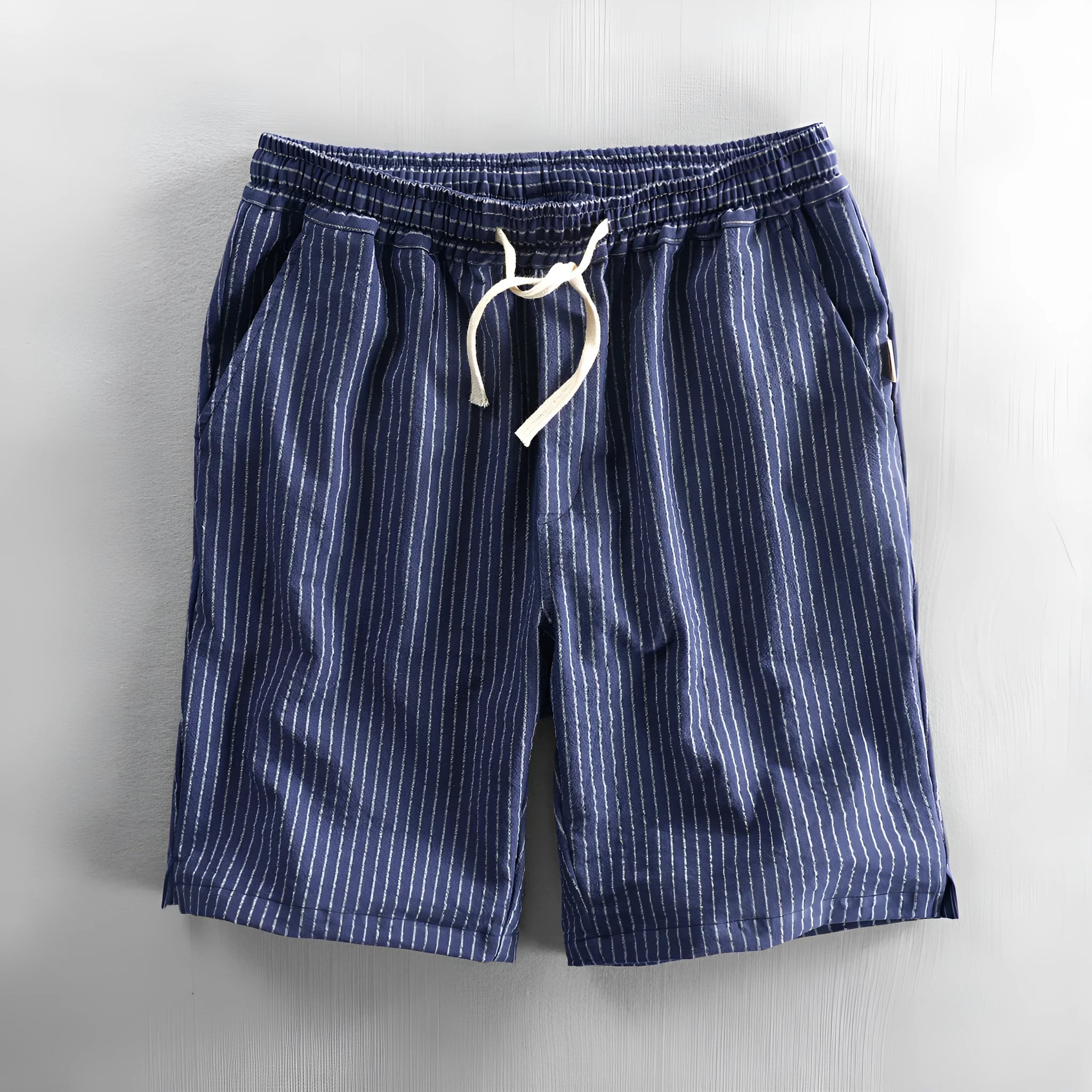 Man wearing black and white striped cotton casual shorts with a loose straight leg and elasticated waist.