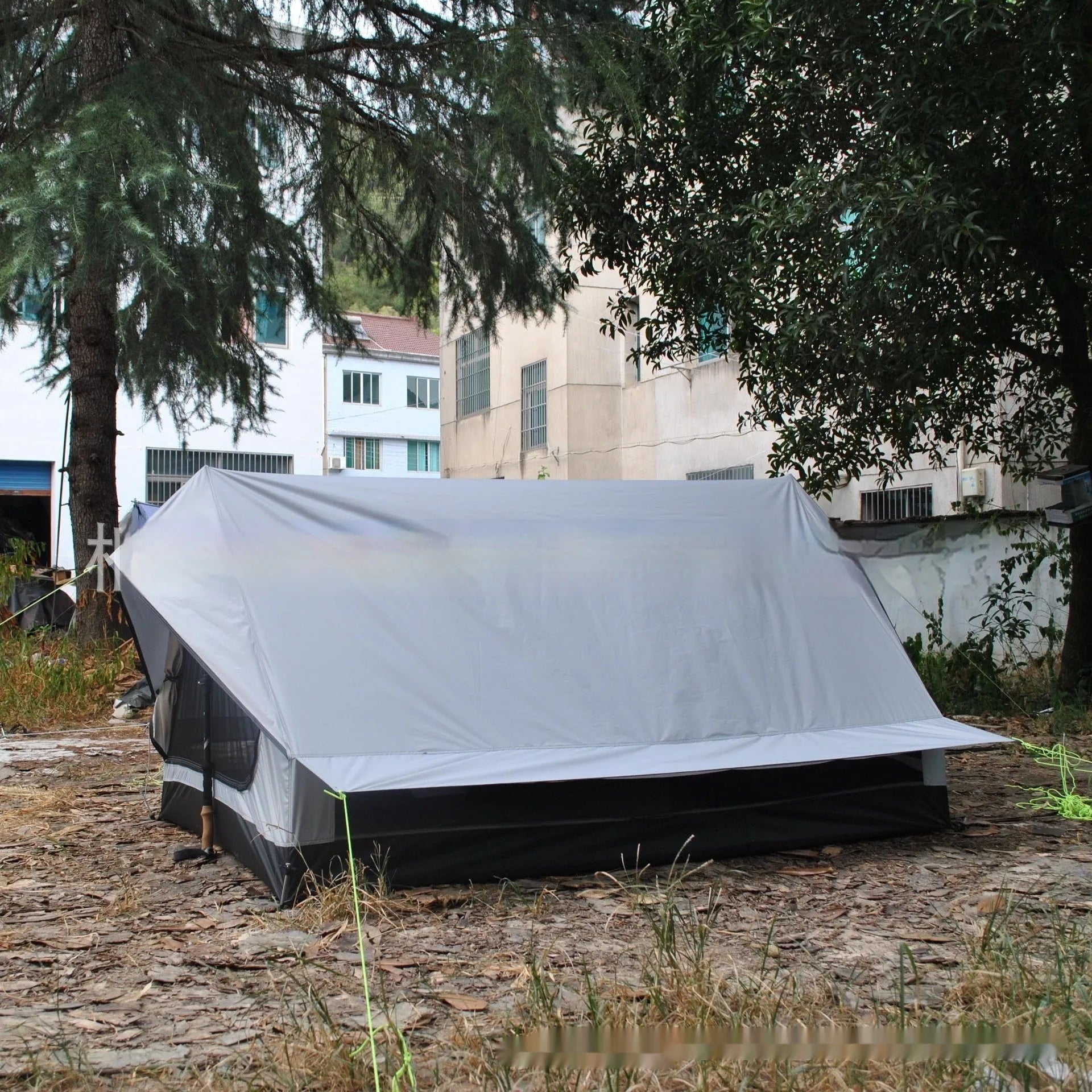 Brown A-line pole-free portable tent with hiking cane support showing interior space for 2-3 people