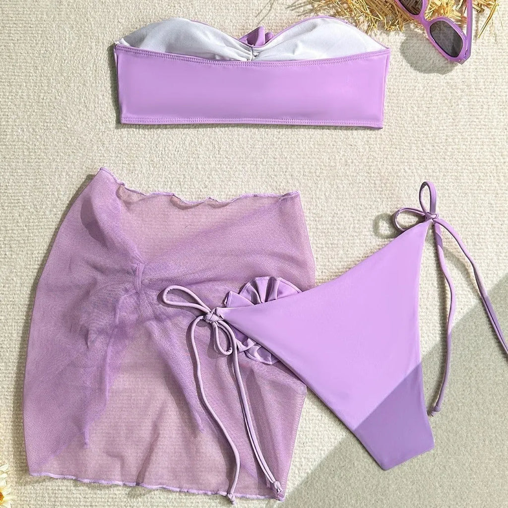 Women's pink tube top swimsuit with 3D flower detail, matching pants, and skirt laid flat.