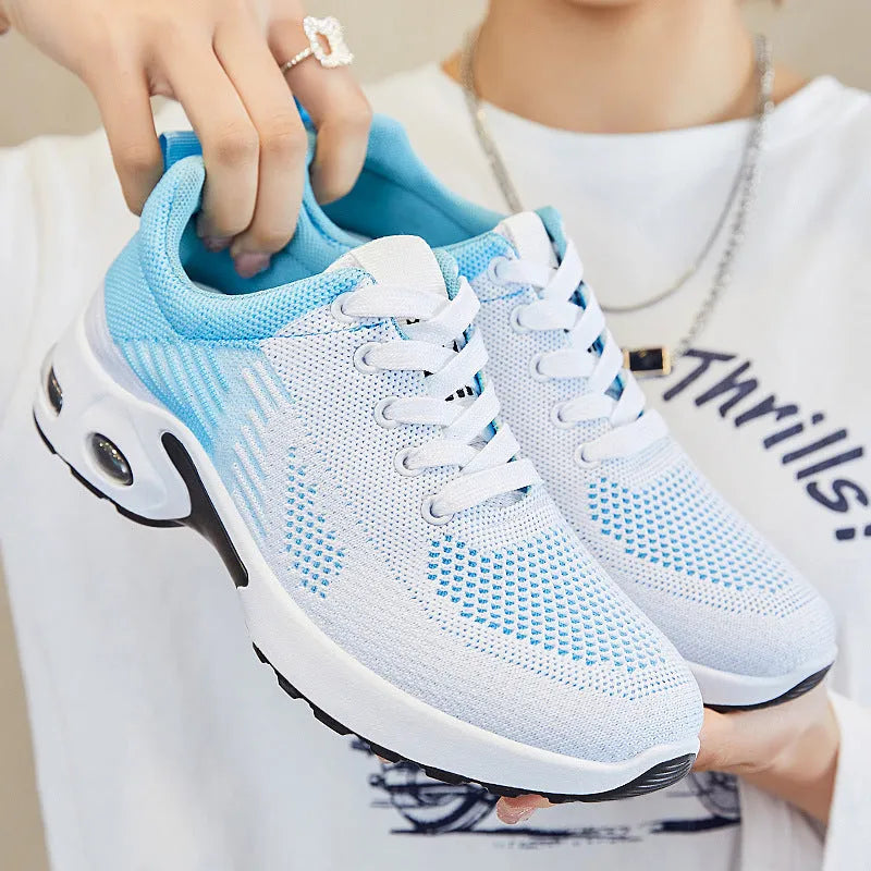 Women's Flyknit casual running shoes in pink with lace-up front and flat PVC sole.