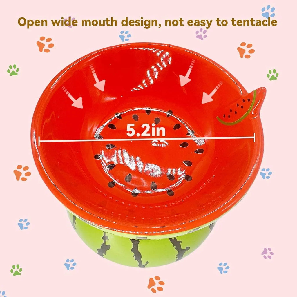 Ceramic raised cat feeder bowl in orange patterned design on a white surface.