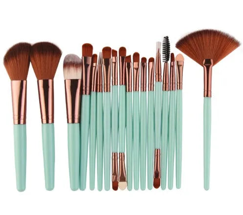 18-piece makeup brush set with fan brushes arranged on a table.