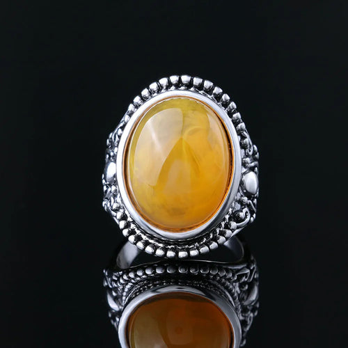 Geometric antique silver ring with fluorescent beeswax amber centre in retro style