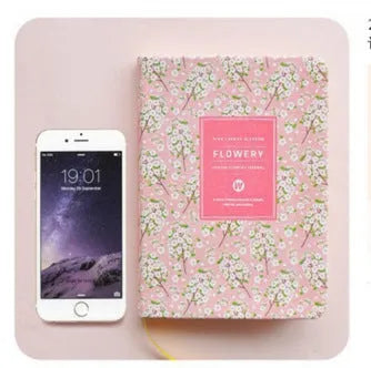 Green fabric imitation leather floral notepad open on a desk, showing custom logo printing and Daolin paper.
