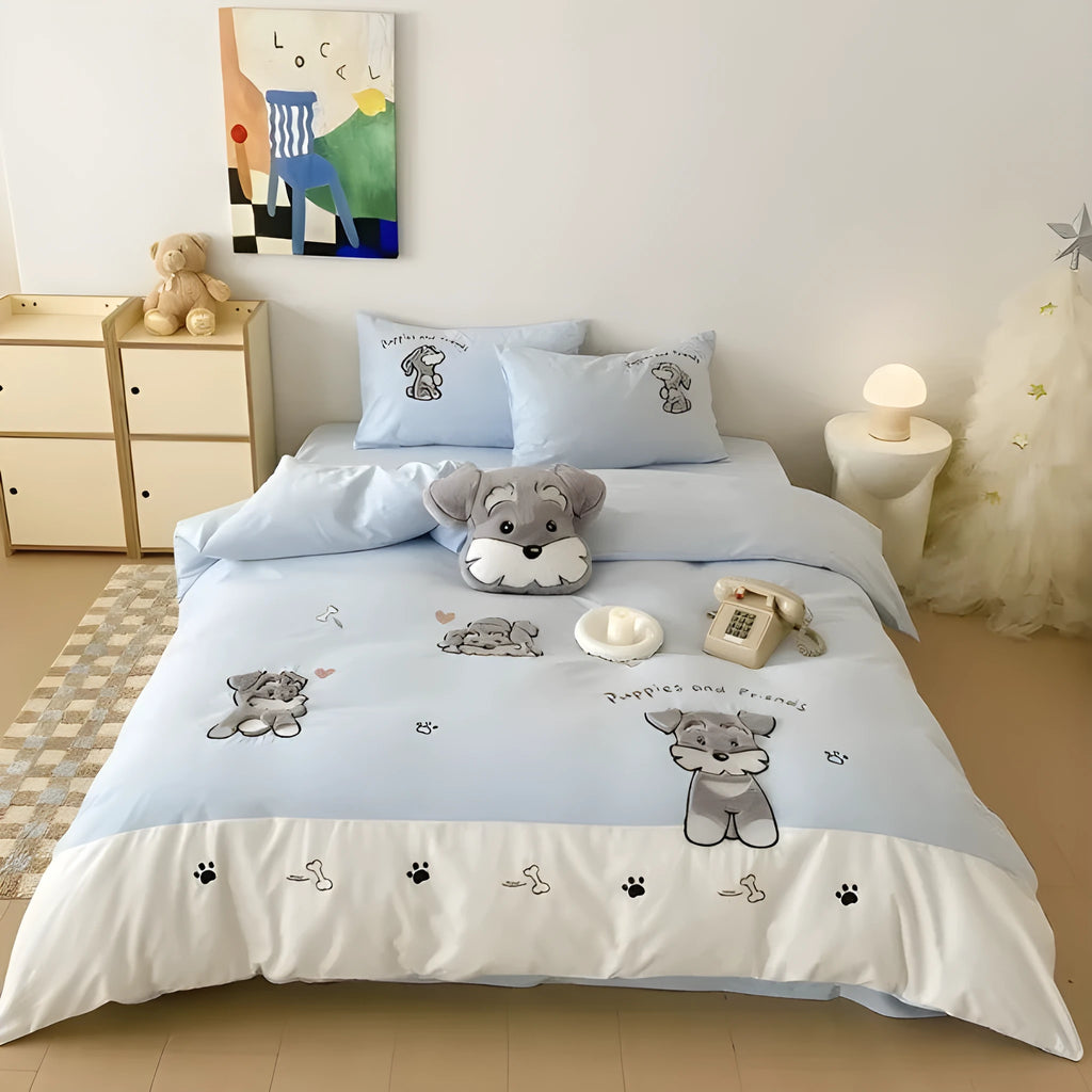 Schnauzer dog cartoon embroidery design on a light-coloured cotton quilt cover and pillowcase from a four-piece bedding set.