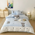 Schnauzer dog cartoon embroidery design on a light-coloured cotton quilt cover and pillowcase from a four-piece bedding set.