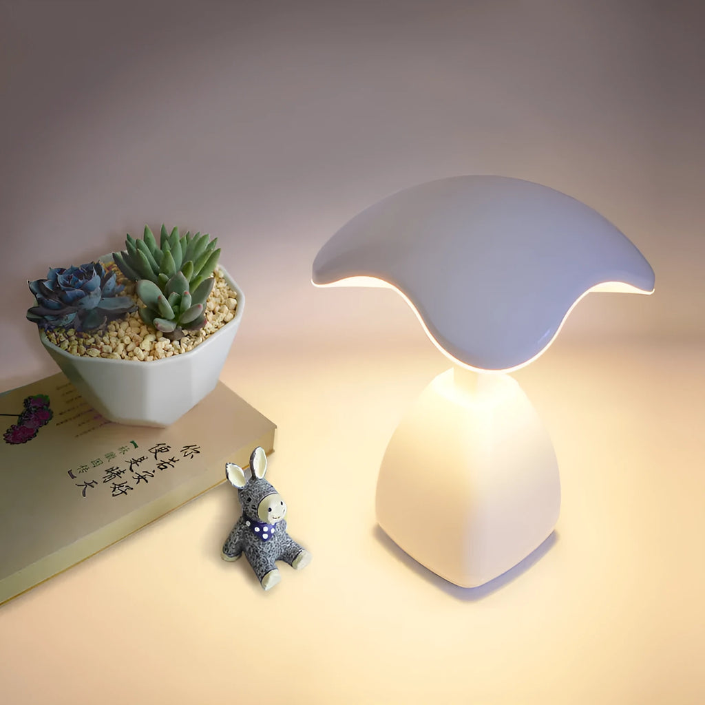 White modern plastic LED desk lamp with touch control on a wooden surface.