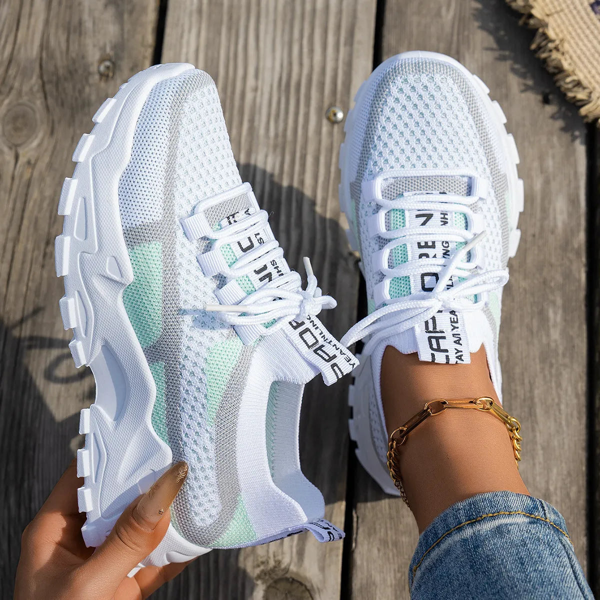 Women's Flyknit Mesh sneakers in a neutral colour showing lace-up design and rubber sole.