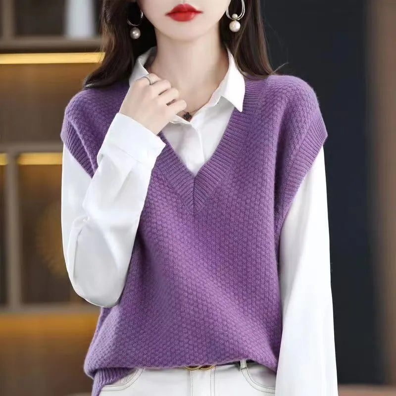 Creamy-white V-neck sleeveless knitted vest with a raised 3D pattern, laid flat.