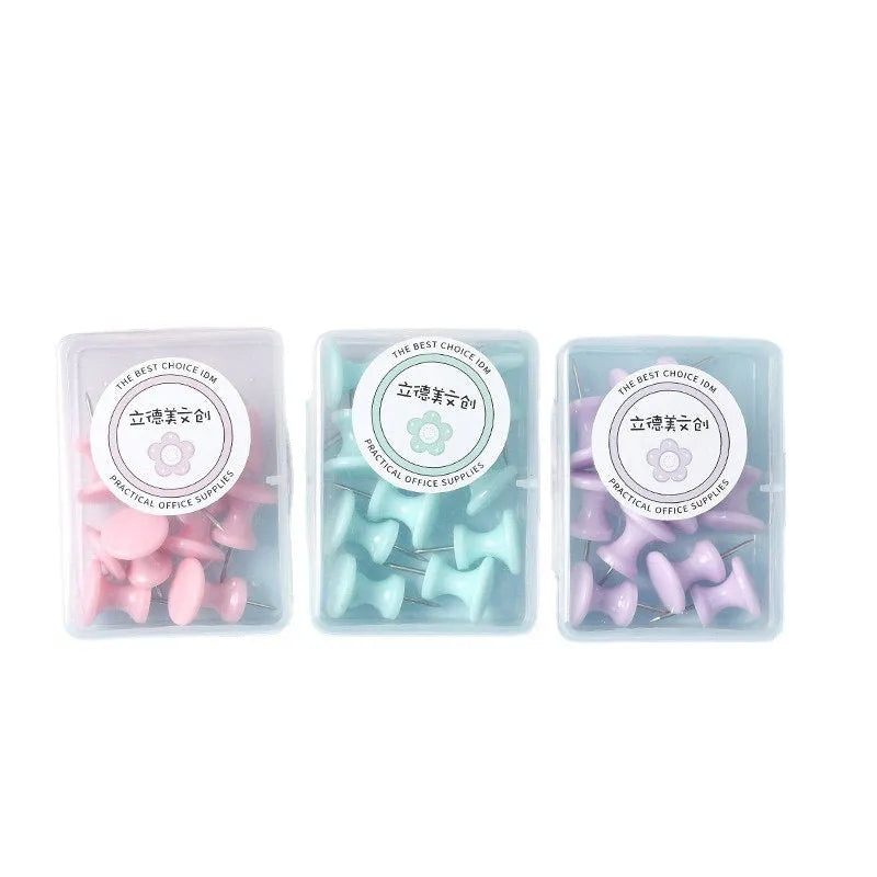 Plastic push pins in mint green, lavender, and pink, showing large and small sizes in a small box.