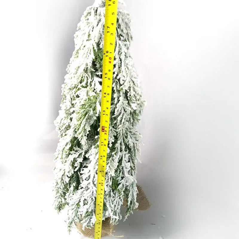 24-inch small artificial Christmas tree with snow spray decoration and built-in lights on desktop