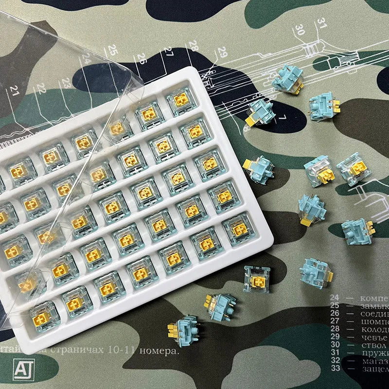 36 Sea Salt Lemon PRO Mute coloured mechanical keyboard switches laid out in rows.