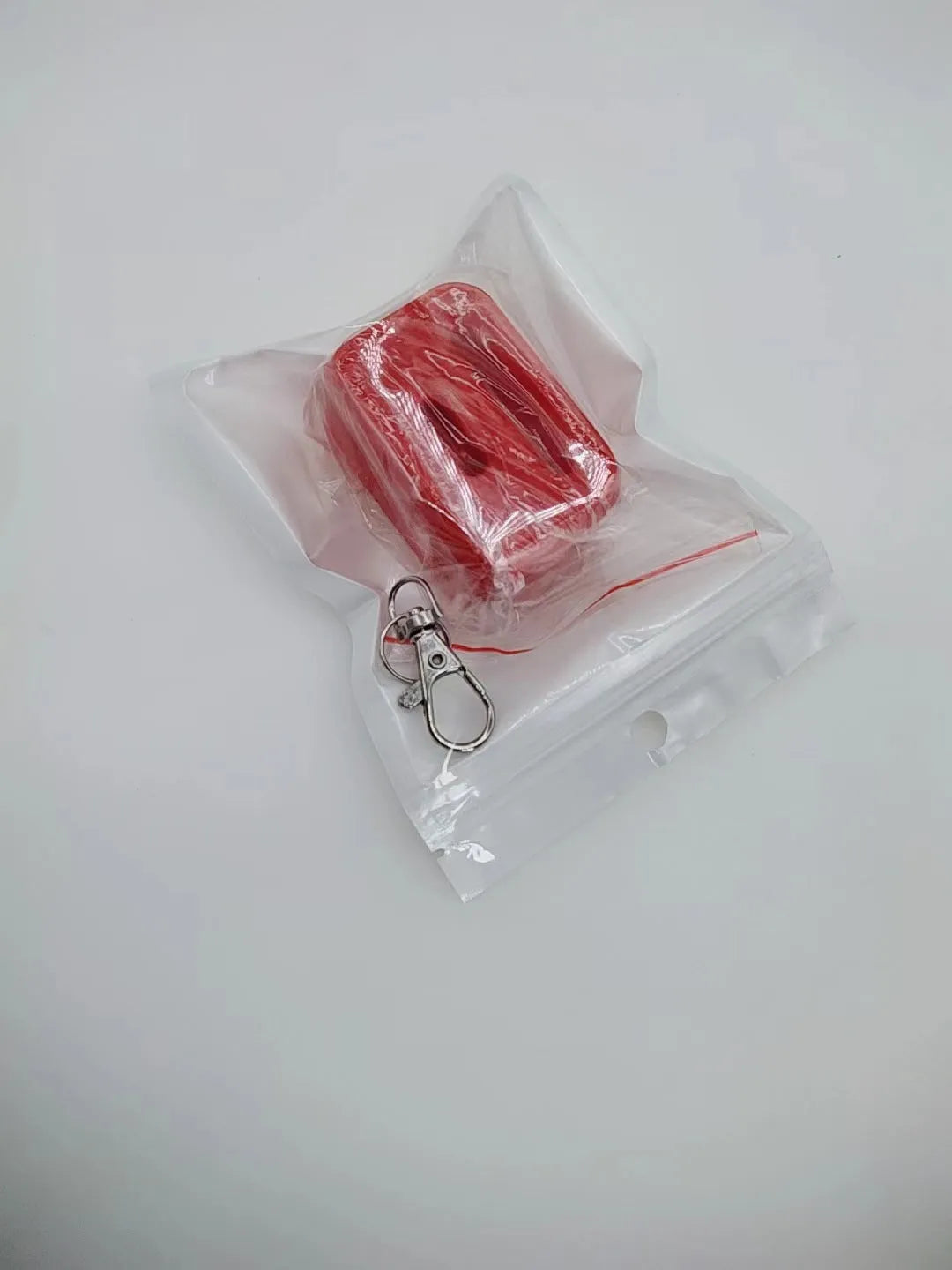 Black and red plastic seat belt buckle protective clamp holder device on a car seat.