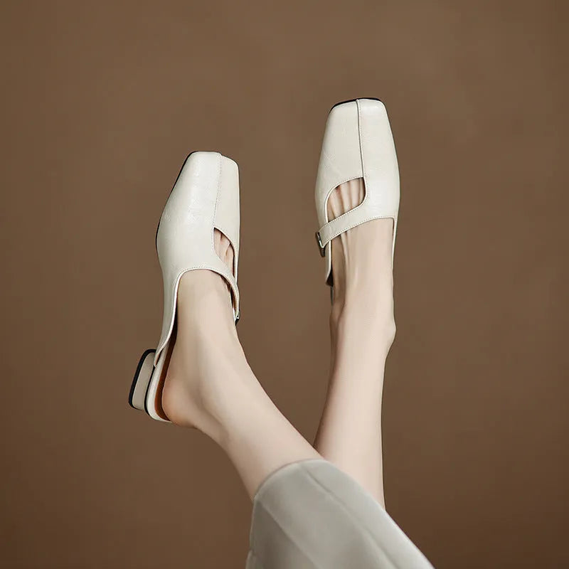 Pair of square-toe casual slippers with a low heel on a rubber sole, shown in a solid colour.