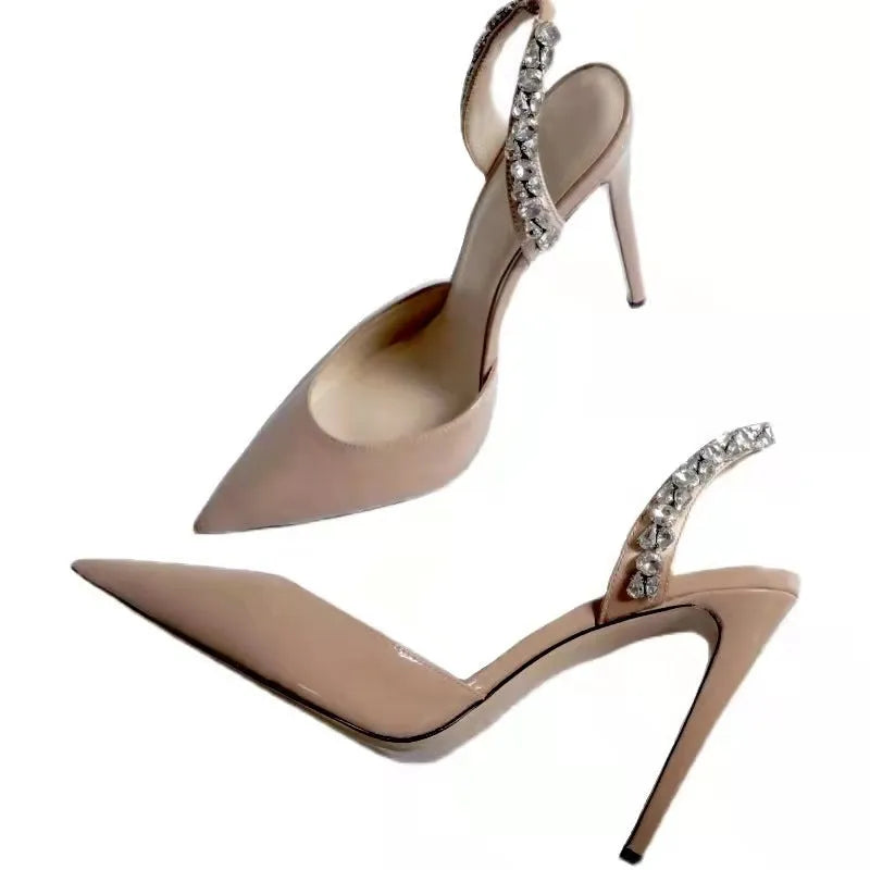 Pointed toe high heel sandals with rhinestone detail on the side, shown in patent leather.
