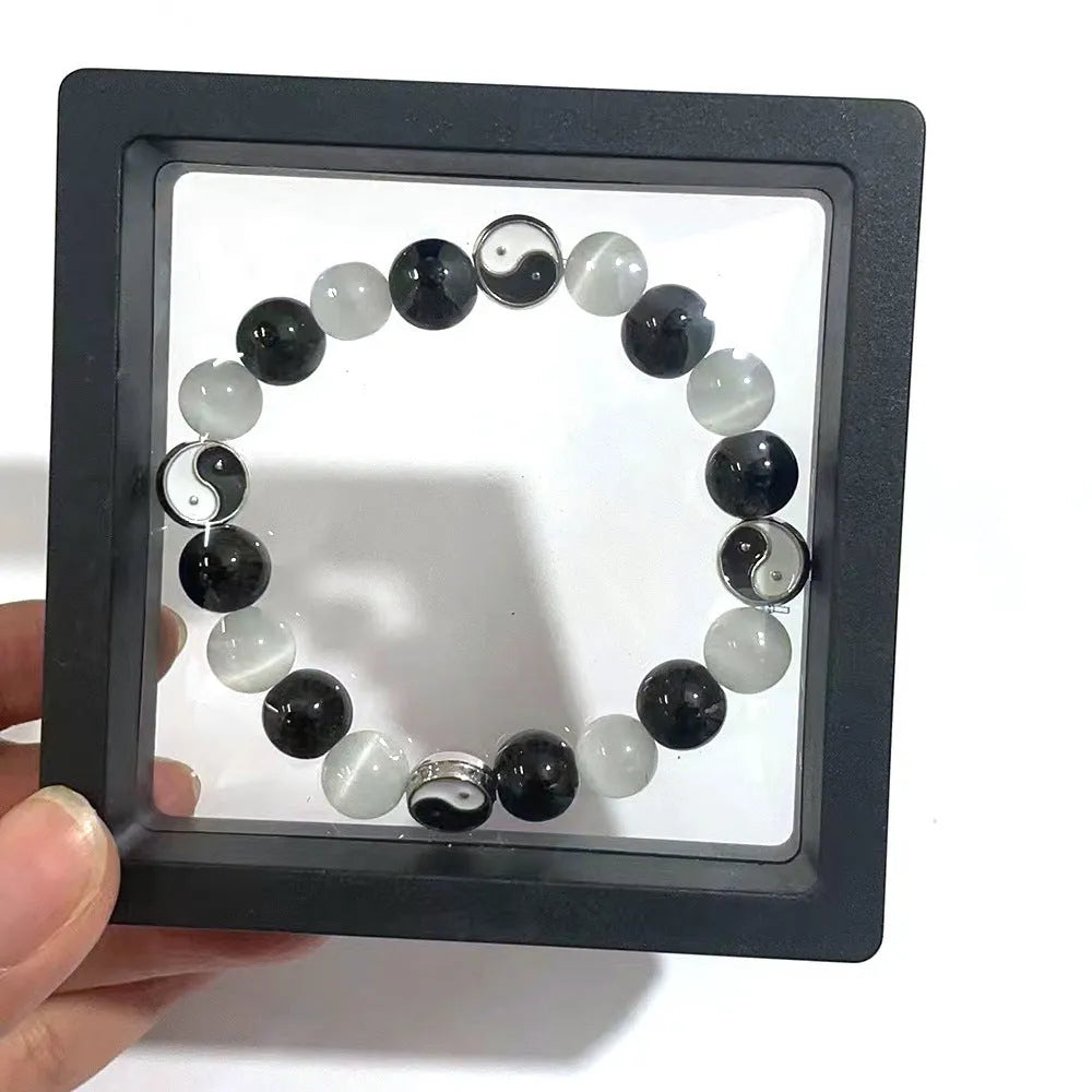 Close-up of a 10mm natural opal and black agate beaded Tai Chi bracelet for men and women.