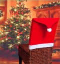 Christmas chair covers set with Santa Claus, Snowman, and Santa hat designs on dining chairs