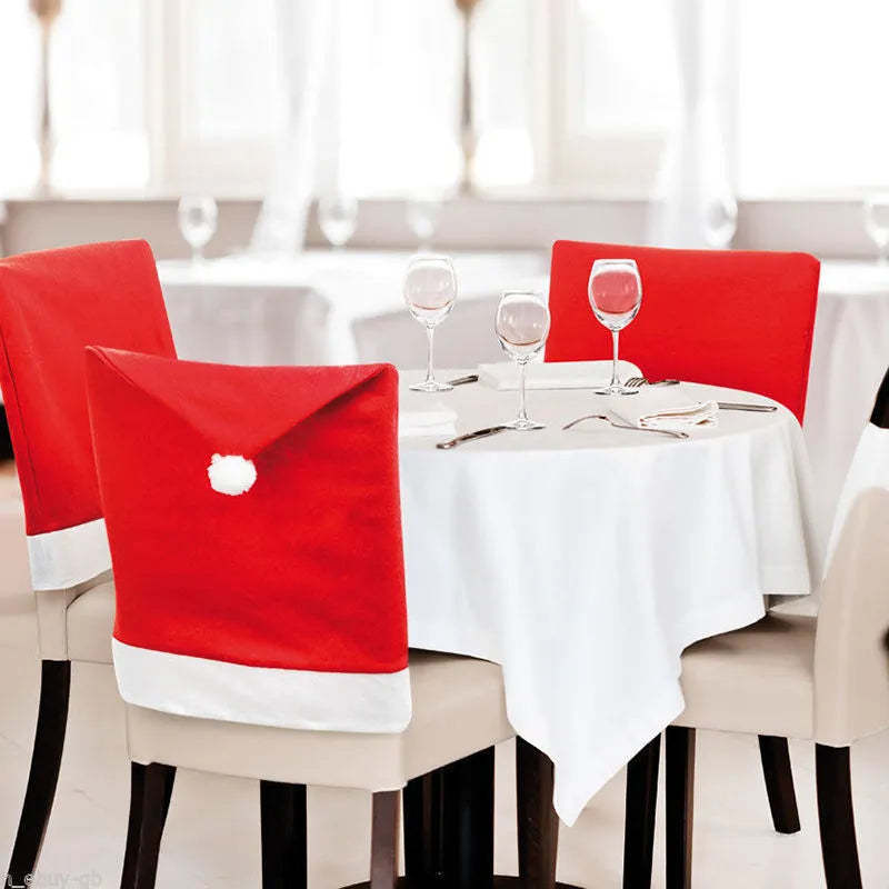 Christmas chair covers set with Santa Claus, Snowman, and Santa hat designs on dining chairs