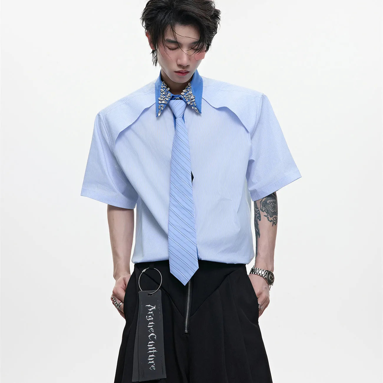 Men's blue and khaki patchwork striped shirt with diamond tie detail and quilted texture.