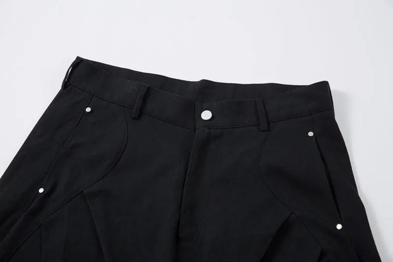 Men's black cotton loose-fit wide-leg trousers with machete pleats and an elasticated waistband