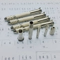 Hand twist drill with two collets and four drill bits on a wooden surface