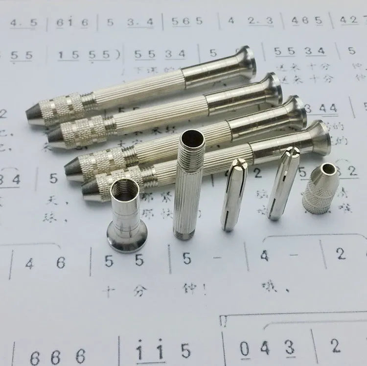 Hand twist drill with two collets and four drill bits on a wooden surface