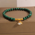 Close-up of a women's white crystal bracelet with a raised lucky bamboo design on the wrist.