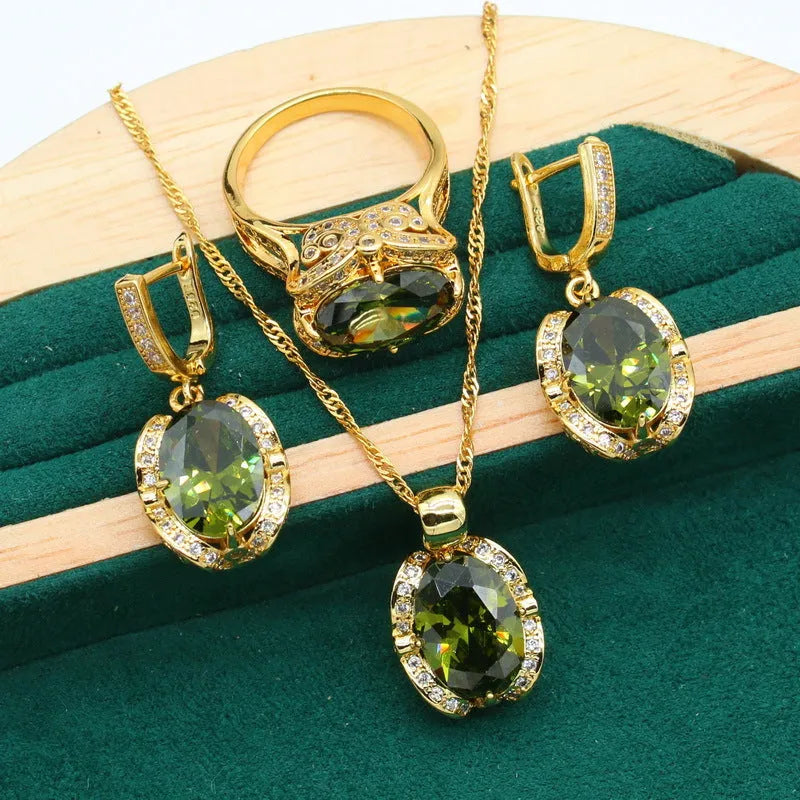 Full rhinestone zircon women's jewellery set showing necklace with snake bones chain, earrings, and ring in olive green or red.