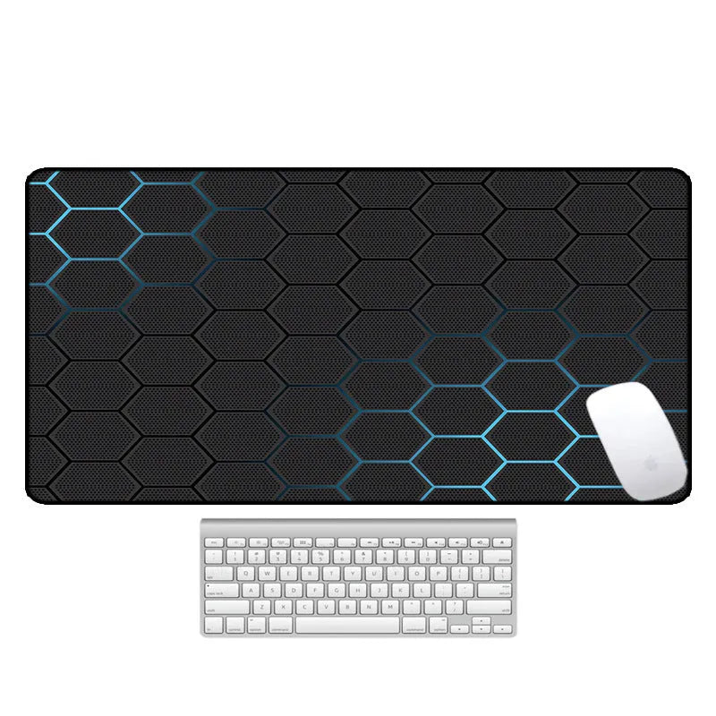 Large black rubber desk mouse pad with a printed geometric pattern, shown on a wooden desk.