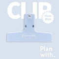 Blue and brown magnetic plastic bill clip holding paper tickets and receipts.