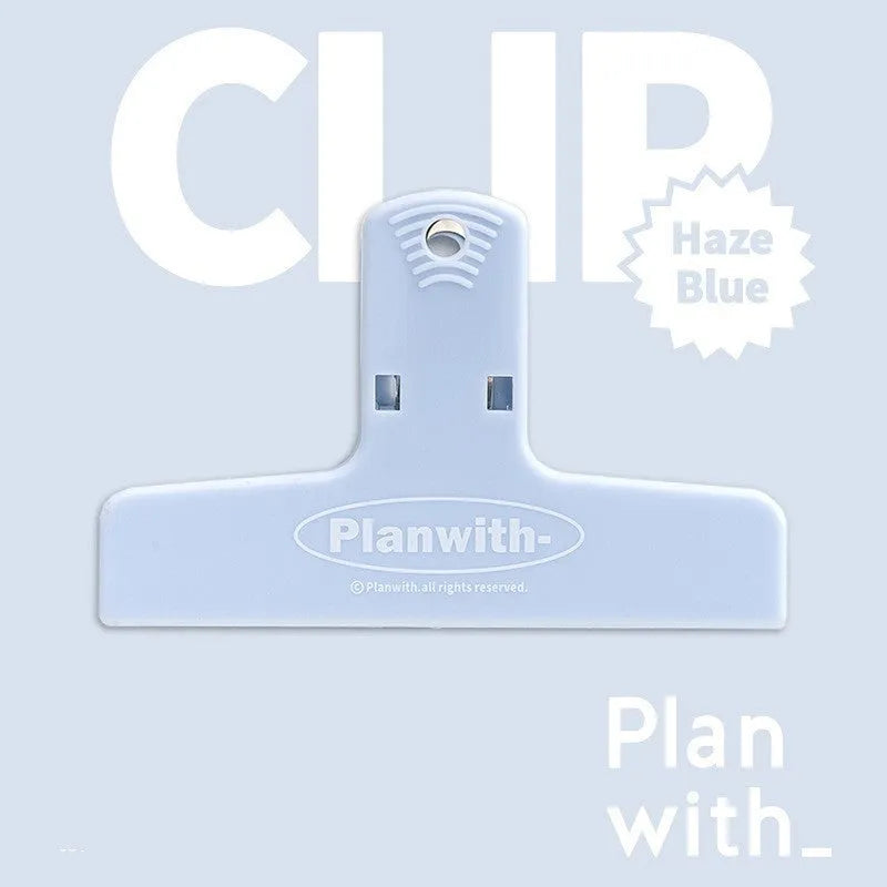 Blue and brown magnetic plastic bill clip holding paper tickets and receipts.
