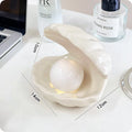 Yellow ceramic ornament tray with a small pink-shell night light placed on it, modern simple style.