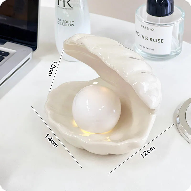 Yellow ceramic ornament tray with a small pink-shell night light placed on it, modern simple style.
