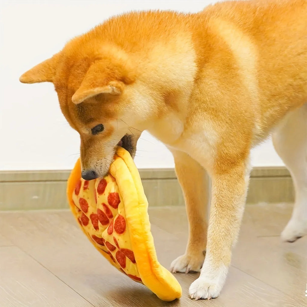 Yellow pizza slice shaped soft fabric dog chew toy with internal squeaker.