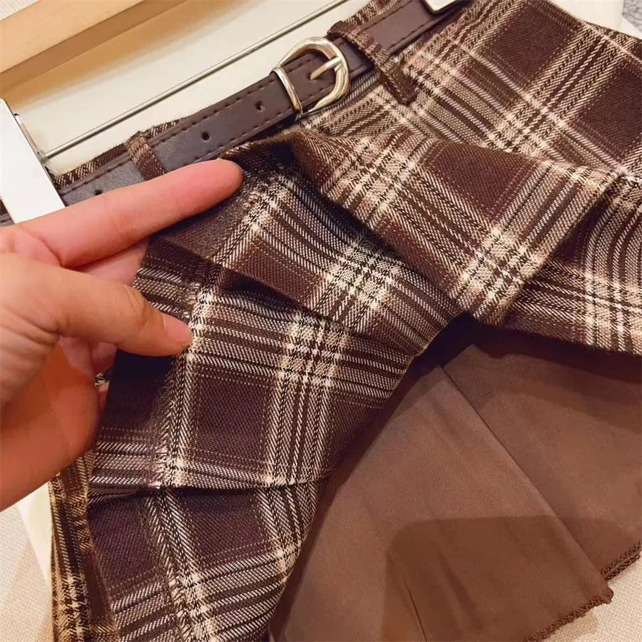 Girls plaid pleated A-line skirt in cotton blend fabric on hanger.